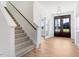 Bright entryway with hardwood floors, staircase, and double doors at 46 Otter Hole Dr, Princeton, NC 27569