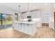 Modern kitchen with white cabinets, quartz countertops and gold hardware at 46 Otter Hole Dr, Princeton, NC 27569