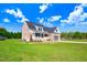 Brick house with a gray garage door and front porch at 46 Otter Hole Dr, Princeton, NC 27569
