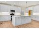 Modern kitchen with white cabinets, island, and stainless steel appliances at 46 Otter Hole Dr, Princeton, NC 27569