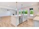 Modern kitchen with white cabinets, island, and view to backyard at 46 Otter Hole Dr, Princeton, NC 27569