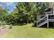 Landscaped backyard with lush lawn and wooded area at 9 Mist Wood Court, Pittsboro, NC 27312
