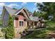 House exterior with stone accents and a manicured lawn at 9 Mist Wood Court, Pittsboro, NC 27312