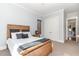 Charming bedroom with wooden bed frame and double doors to closet at 9 Mist Wood Court, Pittsboro, NC 27312