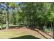 Wooded backyard with grassy area and landscaping at 9 Mist Wood Court, Pittsboro, NC 27312