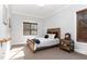 Bright bedroom with a wooden bed frame and large windows at 9 Mist Wood Court, Pittsboro, NC 27312