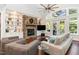 Living room with stone fireplace, hardwood floors, and large windows at 9 Mist Wood Court, Pittsboro, NC 27312