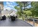 Outdoor deck with seating area and grill, overlooking trees at 9 Mist Wood Court, Pittsboro, NC 27312