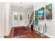 Bright entryway with hardwood floors, double doors, and elegant art at 9 Mist Wood Court, Pittsboro, NC 27312