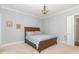 Cozy bedroom with wood bed frame and striped bedding at 9 Mist Wood Court, Pittsboro, NC 27312