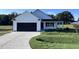 Charming one-story home with a black garage door at 194 Lotus Ave, Smithfield, NC 27577