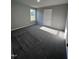 Bright bedroom with a large window and carpet flooring at 194 Lotus Ave, Smithfield, NC 27577