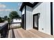 Private deck with wood flooring and a metal railing at 2401 E Main St, Durham, NC 27703