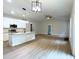 Open concept kitchen with island, stainless steel appliances, and white cabinetry at 114 Shoshone Dr, Louisburg, NC 27549