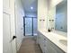 Bathroom with double vanity, quartz countertop, and shower at 114 Shoshone Dr, Louisburg, NC 27549
