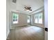 Bright main bedroom with wood-look floors and multiple windows at 114 Shoshone Dr, Louisburg, NC 27549