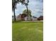 Two-story house with a large backyard and partial view of a neighboring building at 110 S Layton Avenue, Dunn, NC 28334