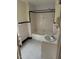 Retro bathroom with black and white tile floor, bathtub, and shower at 110 S Layton Avenue, Dunn, NC 28334