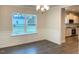 Bright dining room with hardwood floors, chandelier, and view of kitchen at 168 Newport Lndg, Garner, NC 27529