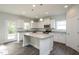 Modern kitchen with white cabinets, granite island and stainless steel appliances at 168 Newport Lndg, Garner, NC 27529