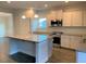Modern kitchen with white cabinets, granite countertops and island at 168 Newport Lndg, Garner, NC 27529