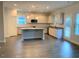 Open kitchen with granite countertops, island, and stainless steel appliances at 168 Newport Lndg, Garner, NC 27529