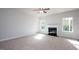 Living room featuring fireplace, neutral carpeting and large windows at 168 Newport Lndg, Garner, NC 27529
