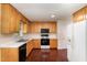 Kitchen with light wood cabinets, white countertops, and black appliances at 1001 Yopon Ct, Raleigh, NC 27603
