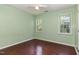 Light green bedroom with wood floors and two large windows at 1001 Yopon Ct, Raleigh, NC 27603