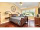 Bright bedroom with wood floors, a ceiling fan, and large windows at 1001 Yopon Ct, Raleigh, NC 27603