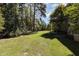 Spacious backyard with grassy area, shed, and playground at 1001 Yopon Ct, Raleigh, NC 27603