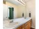 Bathroom with double vanity, large mirror, and light wood cabinets at 1001 Yopon Ct, Raleigh, NC 27603