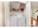 Laundry closet with washer, dryer, and shelving for storage at 1001 Yopon Ct, Raleigh, NC 27603