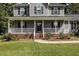Gray house with a covered porch and brick steps at 1001 Yopon Ct, Raleigh, NC 27603