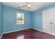 Light blue bedroom with wood floors, a ceiling fan, and a double door closet at 1001 Yopon Ct, Raleigh, NC 27603