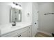 Clean bathroom with white vanity, quartz countertop, and a framed mirror at 217 Temple Ave, Sanford, NC 27330