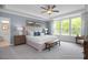 Main bedroom with a large bed, ample natural light, and en-suite bathroom at 5045 Trotter Dr, Raleigh, NC 27603