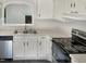 Bright kitchen features white cabinets, new countertops, and stainless steel appliances at 7220 Shellburne Dr, Raleigh, NC 27612