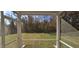 Screened porch overlooking grassy backyard at 19 Longdale Dr, Graham, NC 27253
