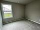 Well-lit bedroom featuring carpet flooring and a window at 749 Sherrill Farm Dr, Benson, NC 27504