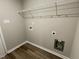 Bright laundry room with built-in shelving and vinyl flooring at 749 Sherrill Farm Dr, Benson, NC 27504