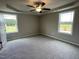 Carpeted bedroom with ceiling fan and two windows at 749 Sherrill Farm Dr, Benson, NC 27504