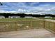 Wooden deck overlooking a grassy backyard and homes at 749 Sherrill Farm Dr, Benson, NC 27504