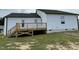 Rear of house showing a deck with stairs leading to the ground at 749 Sherrill Farm Dr, Benson, NC 27504