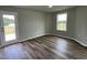 Bedroom with door leading to a deck and hardwood floors at 749 Sherrill Farm Dr, Benson, NC 27504