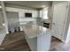 Modern kitchen with large island and white cabinets at 749 Sherrill Farm Dr, Benson, NC 27504