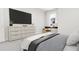 Modern bedroom with large TV and dresser at 4038 Elk Creek Ln # 60, Raleigh, NC 27612