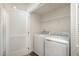 Bright laundry room with washer, dryer, and shelving at 1109 Pale Moss Dr, Durham, NC 27704
