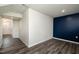 Long hallway with wood-look floors and access to other rooms at 1109 Pale Moss Dr, Durham, NC 27704