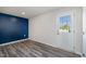 Storage room with a door leading outside and blue accent wall at 1109 Pale Moss Dr, Durham, NC 27704